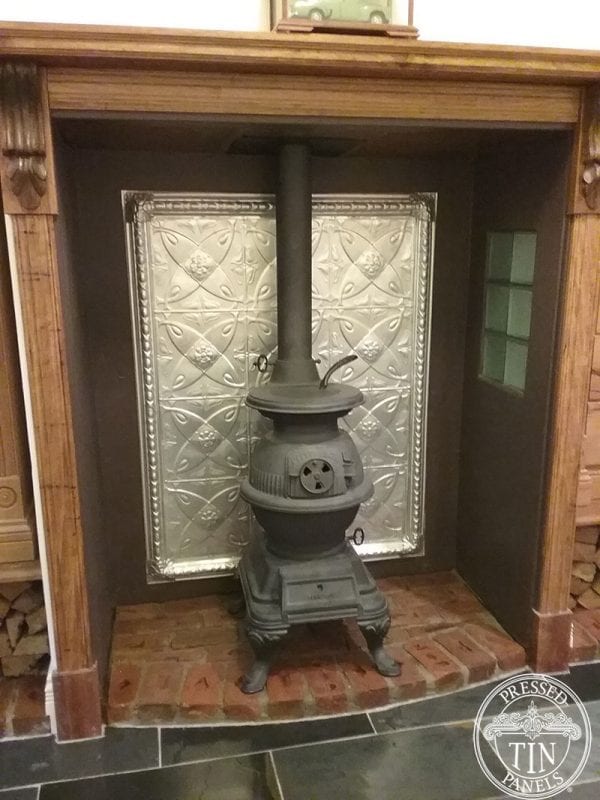 pressed tin panels carousel frame feature behind pot belly stove